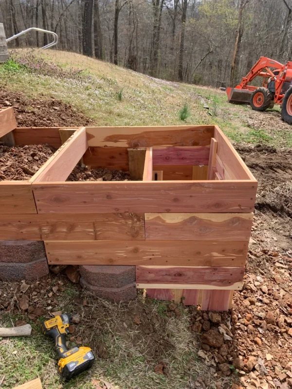 A wooden box with some dirt on top of it